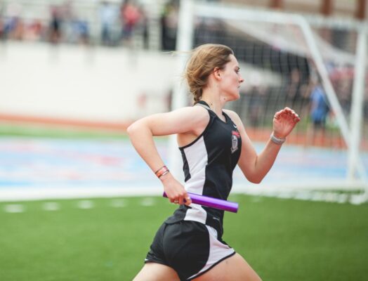 Runner with baton on track