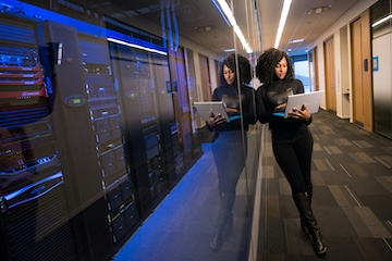 Woman working in a server room.